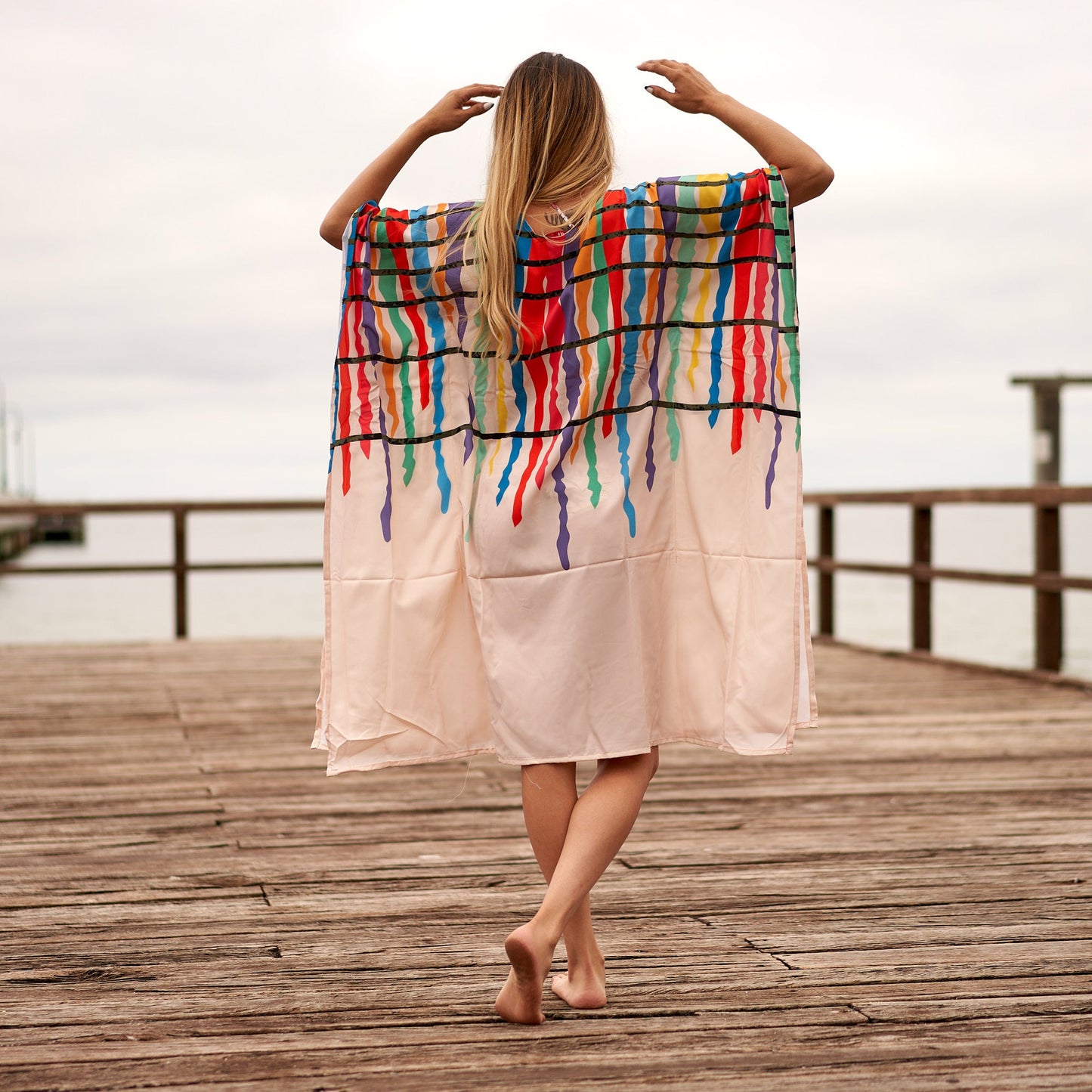 Woman in floral kaftan kimono posing
